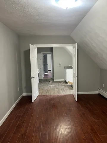 a view of a room with wooden floor