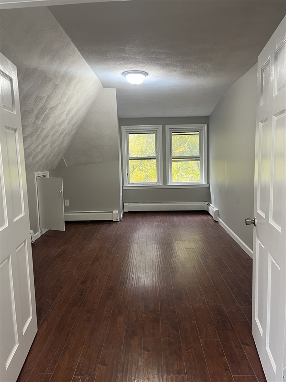 8 Wakefield Avenue, Unit 3R Wakefield, MA 01880 - Photo 4 of 7 an empty room with wooden floor and windows
