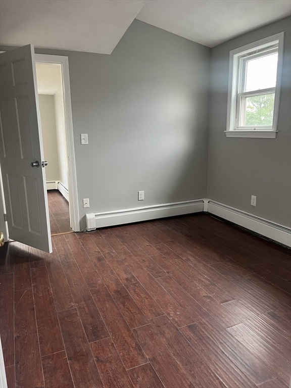 8 Wakefield Avenue, Unit 3R Wakefield, MA 01880 - Photo 5 of 7 an empty room with wooden floor and windows