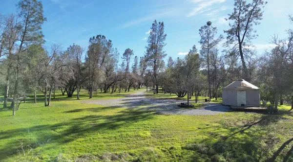 a view of a house with swimming pool and trees