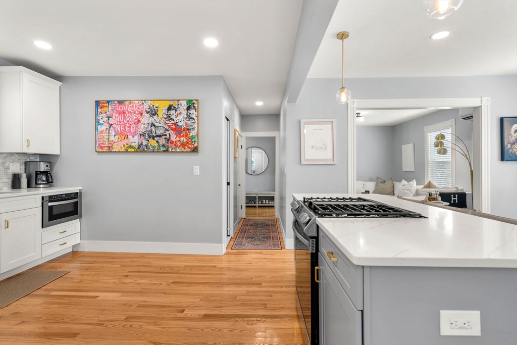 26 Clark Street Danvers, MA 01923 - Photo 12 of 42 a kitchen with stainless steel appliances granite countertop a stove and a sink