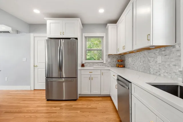 a kitchen with a refrigerator sink and cabinets