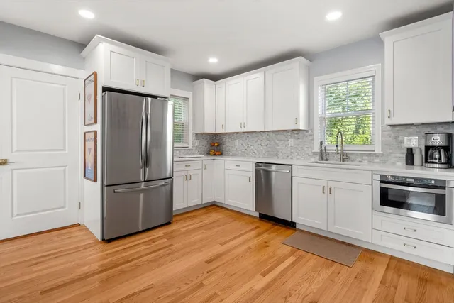 a kitchen with stainless steel appliances granite countertop a refrigerator and a stove