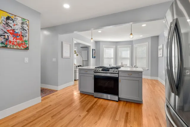 a kitchen with a cabinets and wooden floor