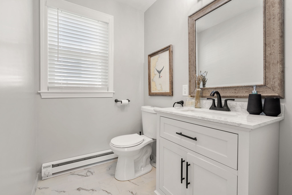 26 Clark Street Danvers, MA 01923 - Photo 18 of 42 a bathroom with a toilet sink and mirror