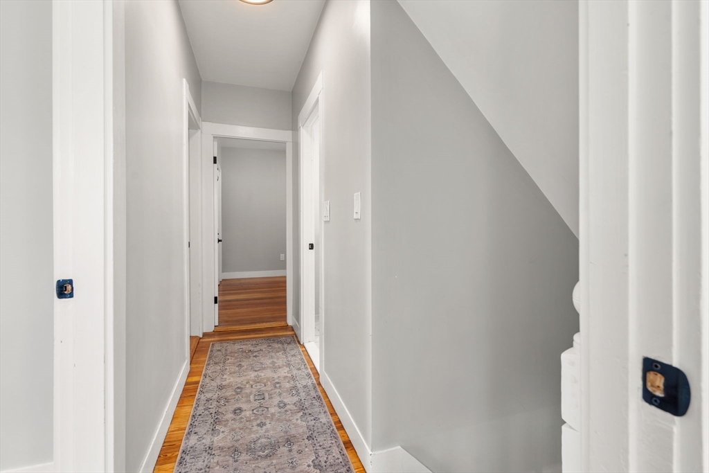 26 Clark Street Danvers, MA 01923 - Photo 21 of 42 a view of a hallway with wooden floor and staircase