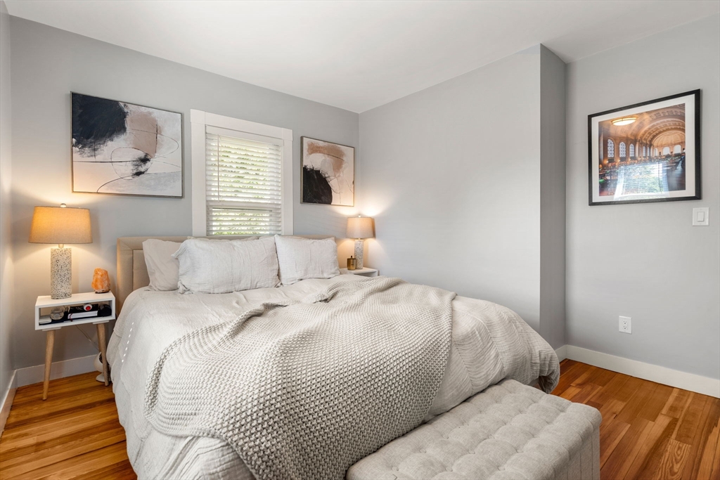 26 Clark Street Danvers, MA 01923 - Photo 22 of 42 a bedroom with a bed and a painting on the wall