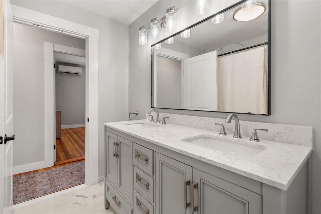 26 Clark Street Danvers, MA 01923 - Photo 25 of 42 a bathroom with a sink double vanity and a mirror