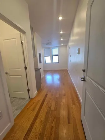 a view of a room with wooden floor and staircase