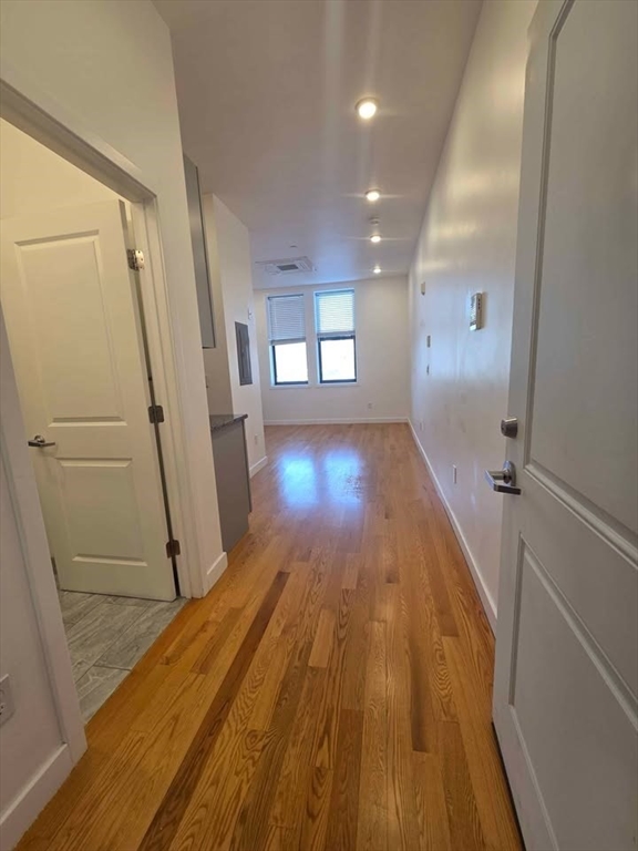 64 Market Street, Unit 408 Lynn, MA 01901 - Photo 1 of 9 a view of a room with wooden floor and staircase
