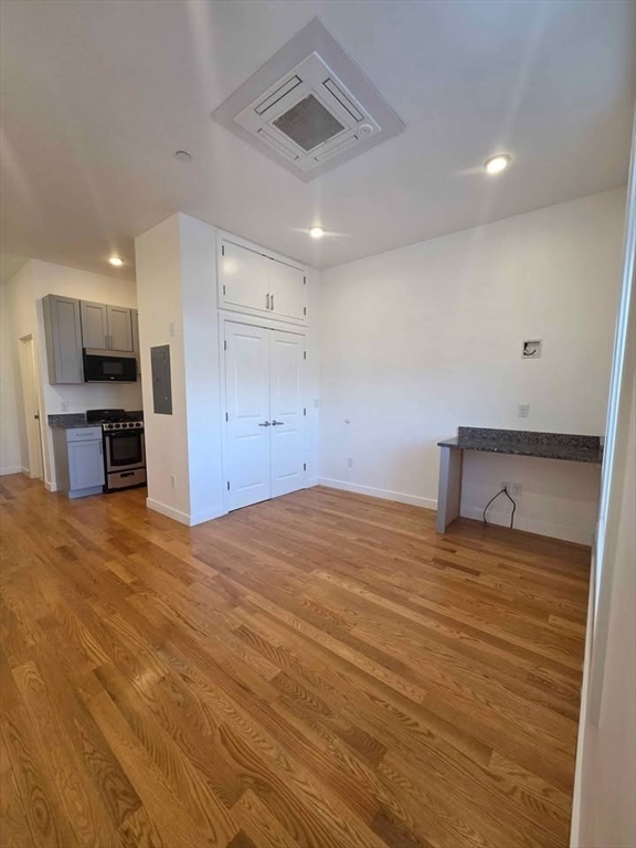 64 Market Street, Unit 408 Lynn, MA 01901 - Photo 2 of 9 a view of a kitchen with a sink and a refrigerator