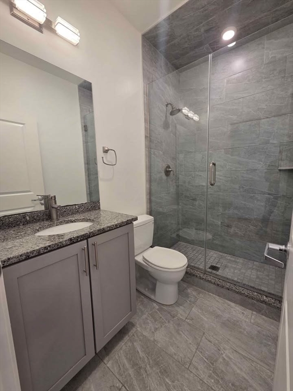 64 Market Street, Unit 408 Lynn, MA 01901 - Photo 5 of 9 a bathroom with a granite countertop sink a toilet and shower
