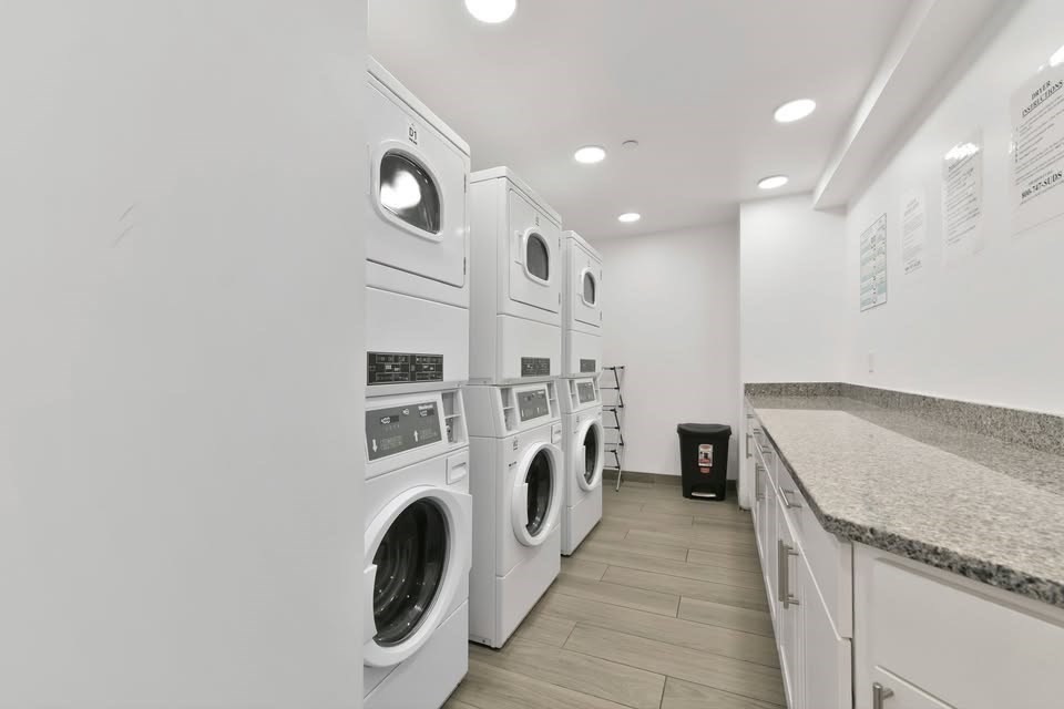 64 Market Street, Unit 408 Lynn, MA 01901 - Photo 8 of 9 a bathroom with a sink and a washer dryer