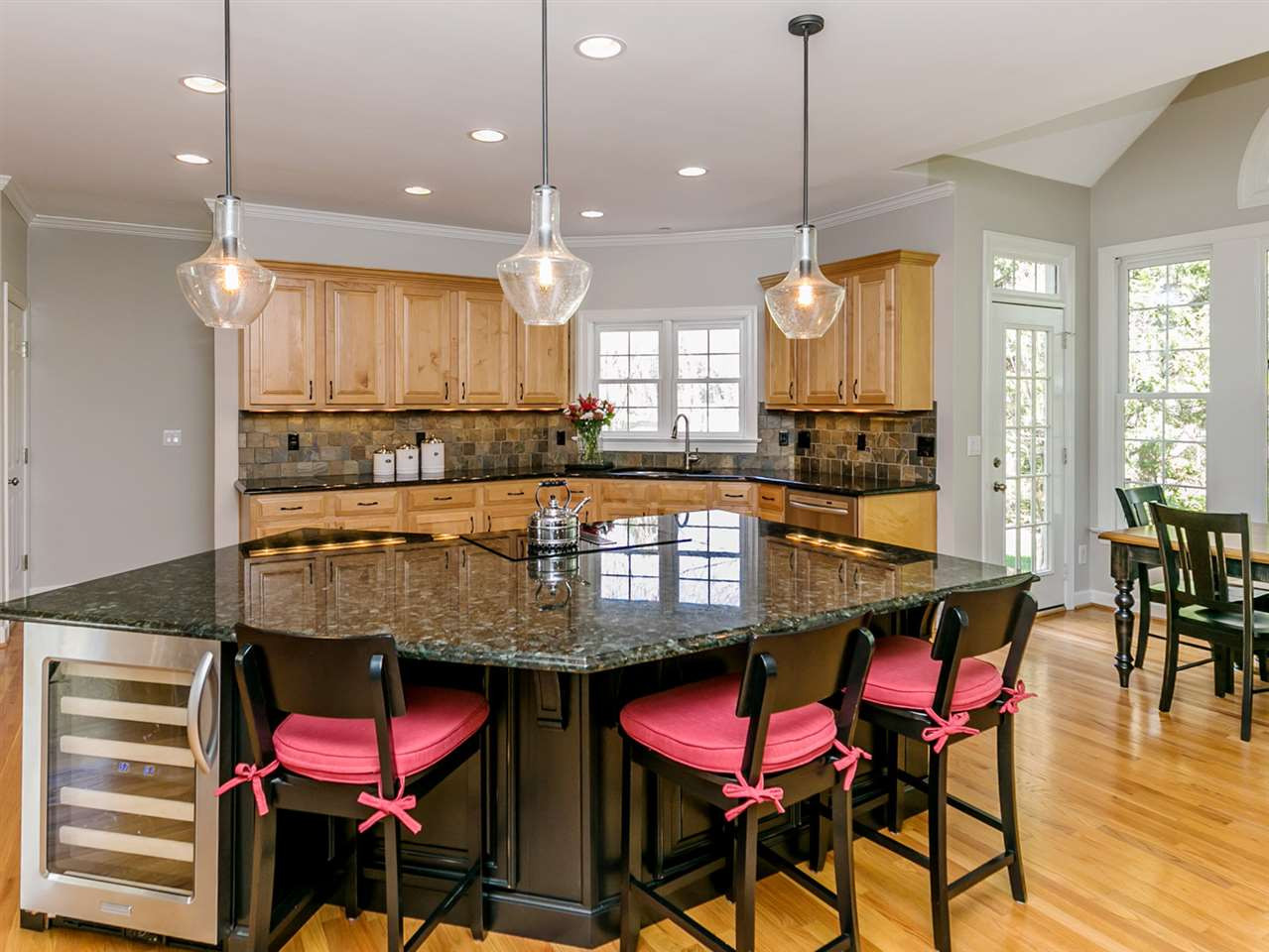 Newly Expanded Kitchen Island with Updated Pendant Lights Kitchen