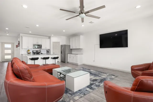a view of a workspace with furniture and a window