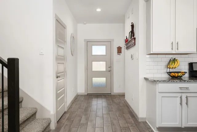 a kitchen with granite countertop a stove sink and refrigerator