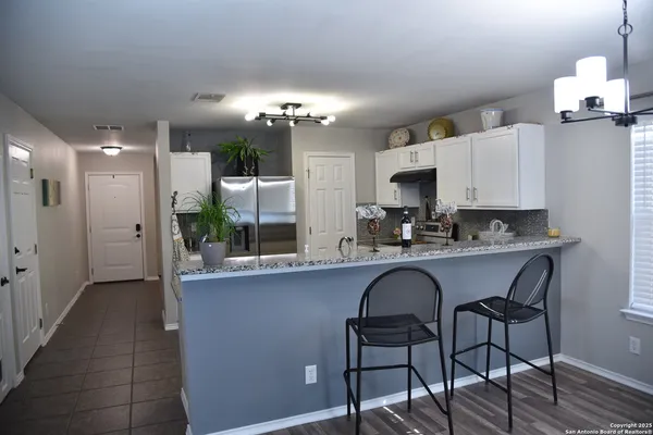 a view of a dining room with furniture and chandelier