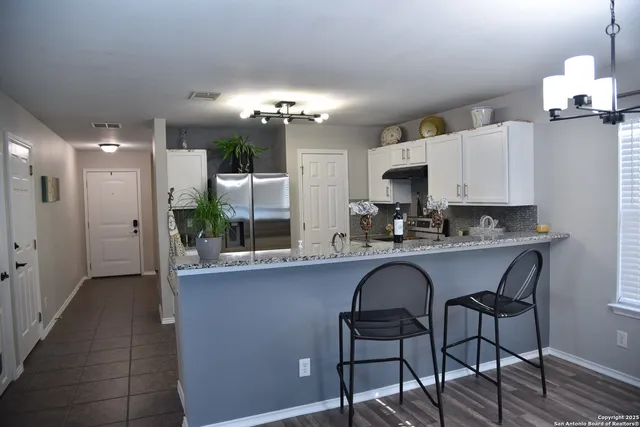 a view of a dining room with furniture and chandelier
