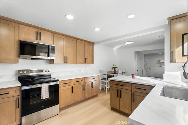 a kitchen with a stove sink and microwave