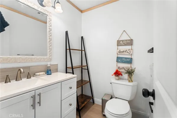 a bathroom with a sink mirror vanity and toilet