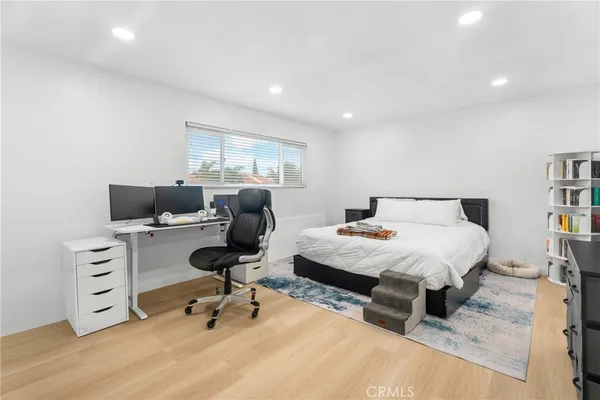 a bedroom with a bed and a desk