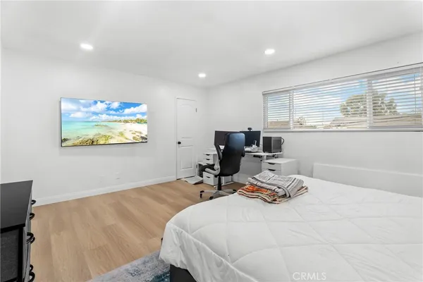 a bedroom with a bed a desk and chair