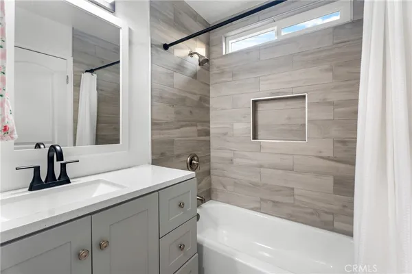 a bathroom with a sink a bathtub and a shower