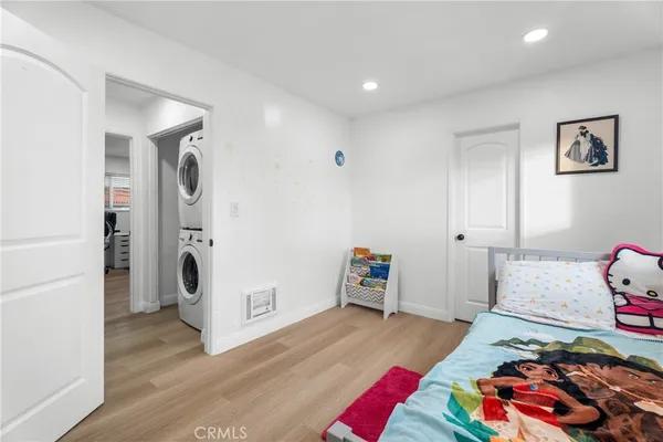 a bedroom with furniture and a wooden floor
