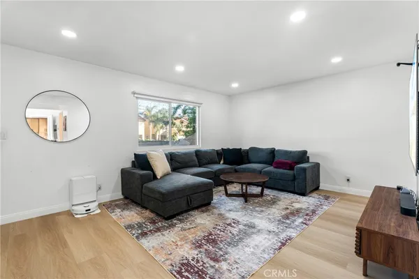 a living room with furniture and a mirror