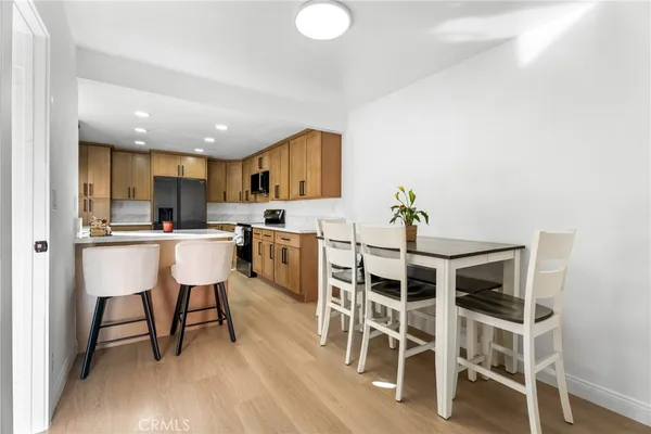 a view of a dining room kitchen with furniture and wooden floor
