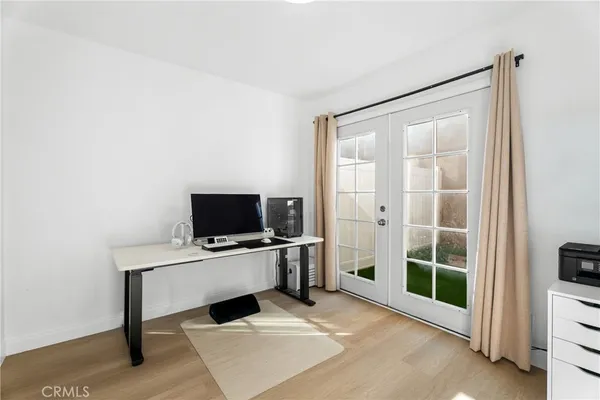 a view of a workspace with furniture and a flat screen tv