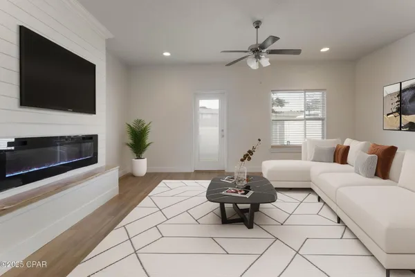 a living room with furniture and a flat screen tv