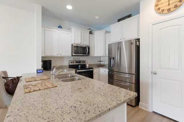 a kitchen with a refrigerator a microwave a sink and a refrigerator