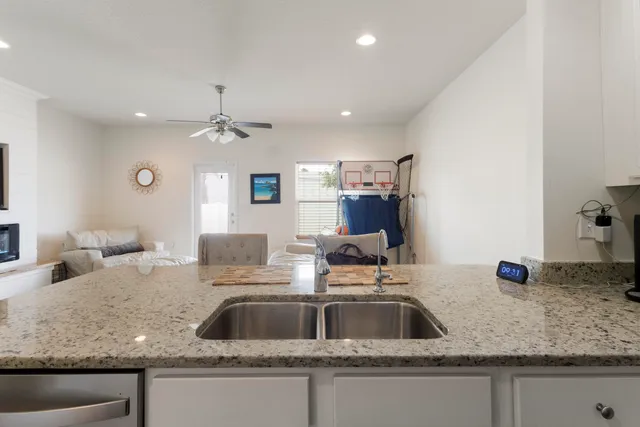 a kitchen with a sink and a mirror