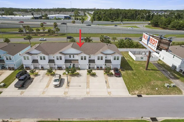 an aerial view of a house with a yard