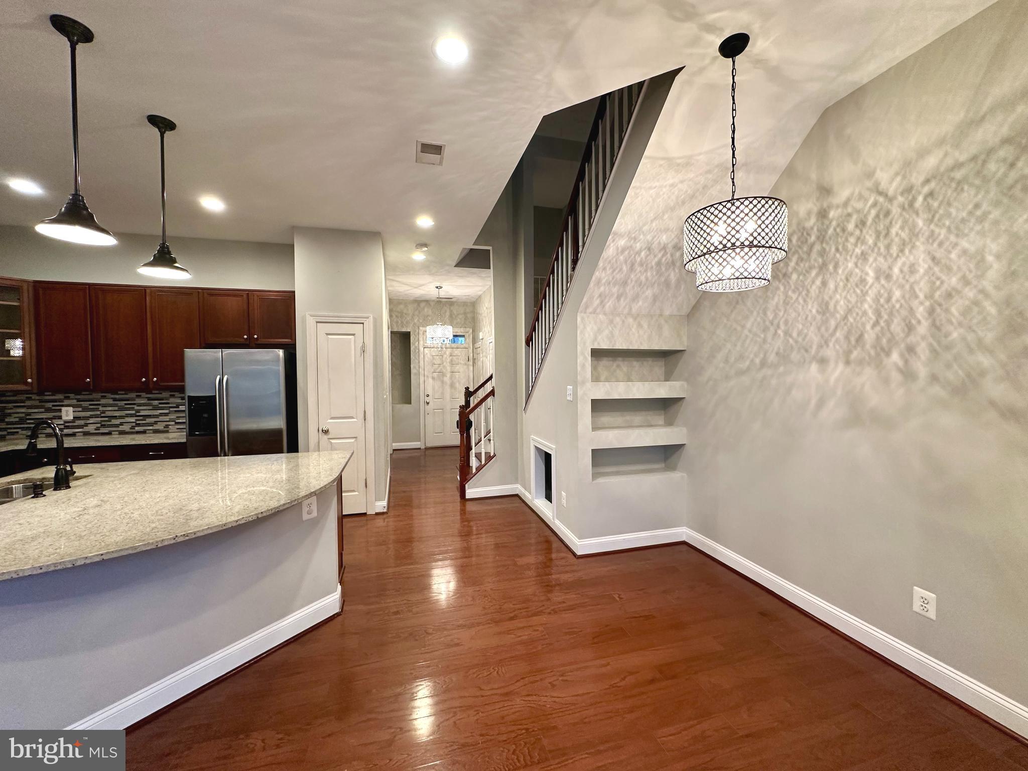 9032 Ribbon Falls Loop Bristow, VA 20136 - Photo 9 of 31 a view of a kitchen with cabinets and wooden floor