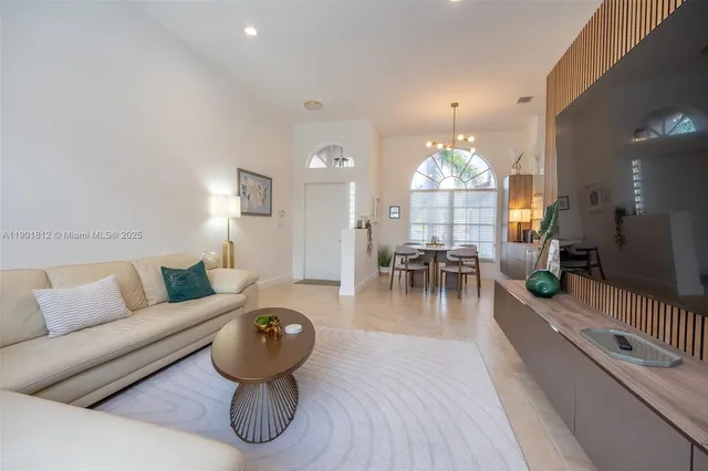 a living room with furniture a chandelier and a chandelier