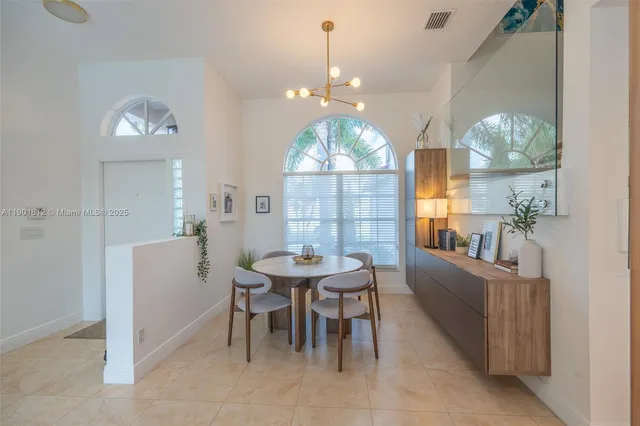 a view of a dining room with furniture and chandelier