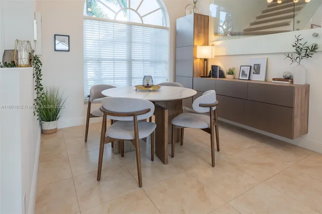a view of a dining room with furniture and window