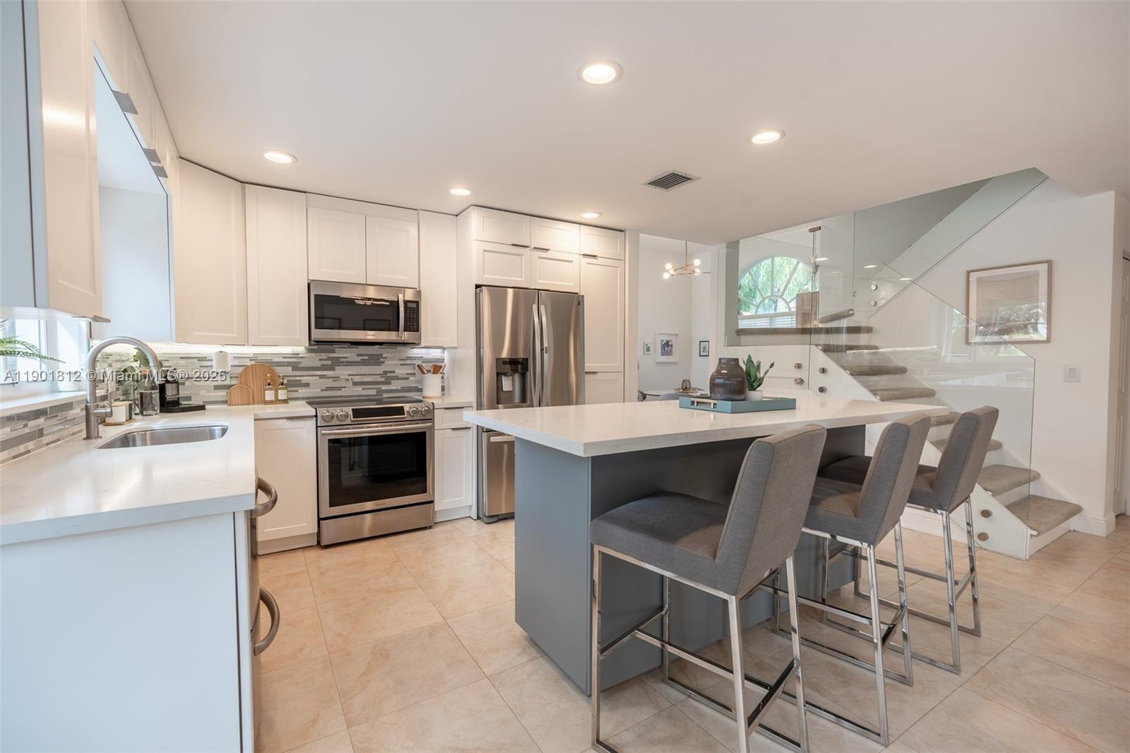 18004 Southwest 20th Street Miramar, FL 33029 - Photo 22 of 49 a kitchen with stainless steel appliances a stove a sink refrigerator and a microwave