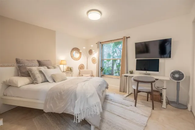 a bedroom with a bed and a flat screen tv