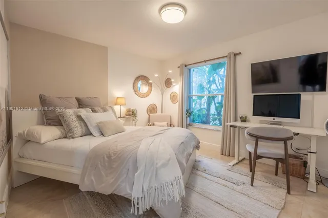 a bedroom with a bed and a flat screen tv