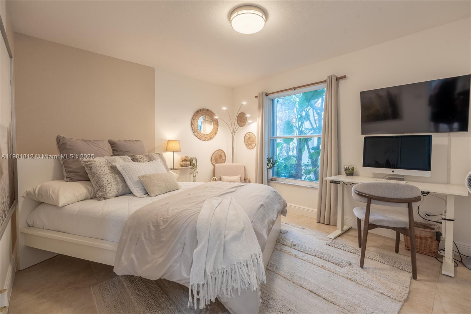 18004 Southwest 20th Street Miramar, FL 33029 - Photo 28 of 49 a bedroom with a bed and a flat screen tv