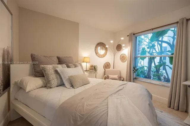 a bedroom with a large bed and a large window