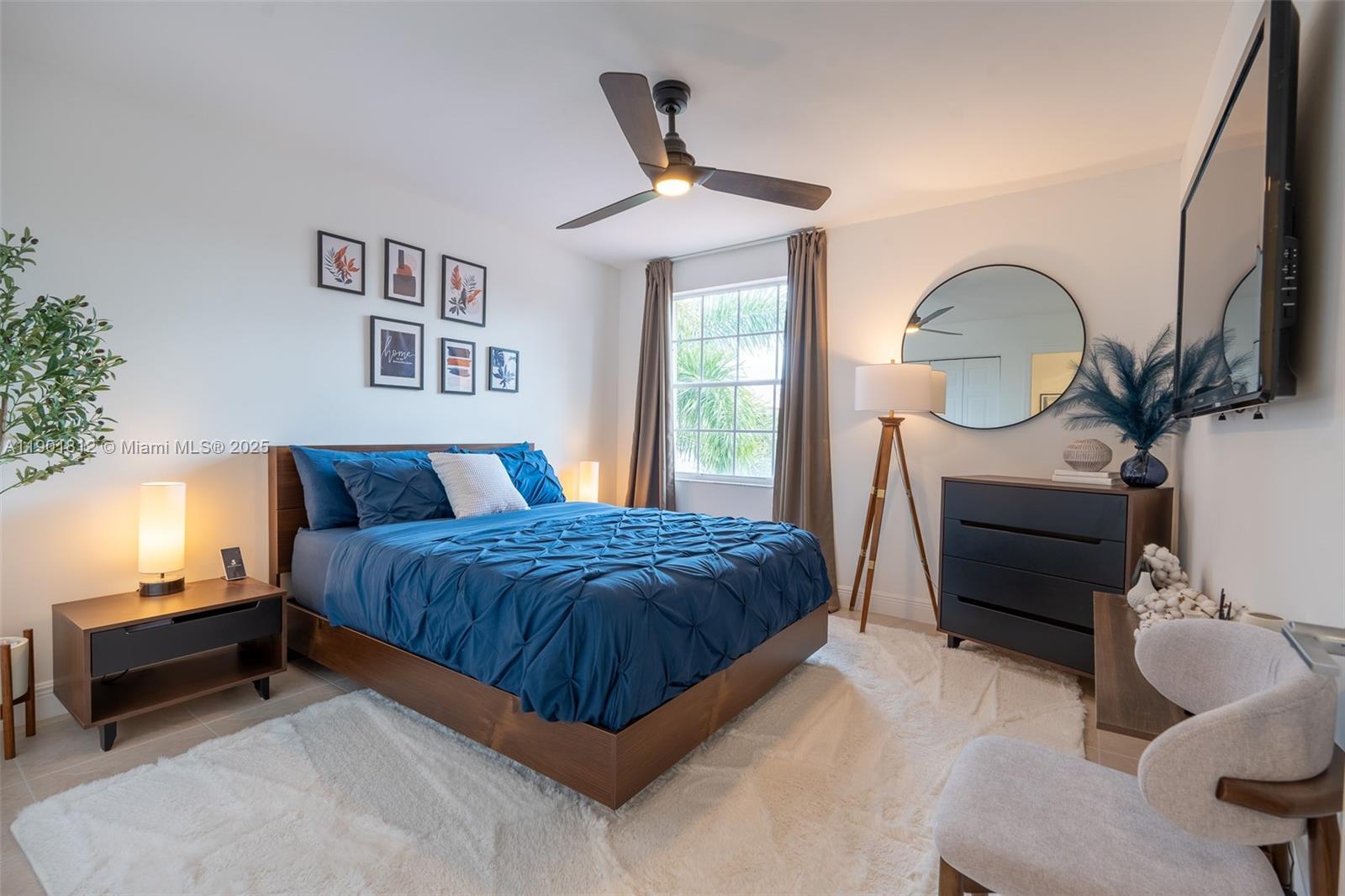 18004 Southwest 20th Street Miramar, FL 33029 - Photo 33 of 49 a bedroom with a bed and a chandelier