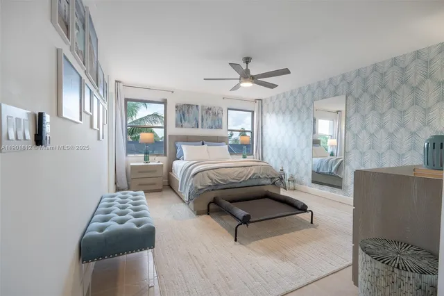 a bedroom with a bed mirror and window