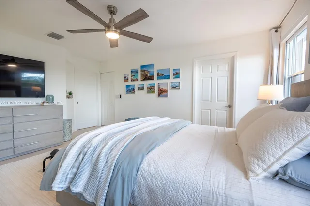 a bathroom with a tub a sink and a large window