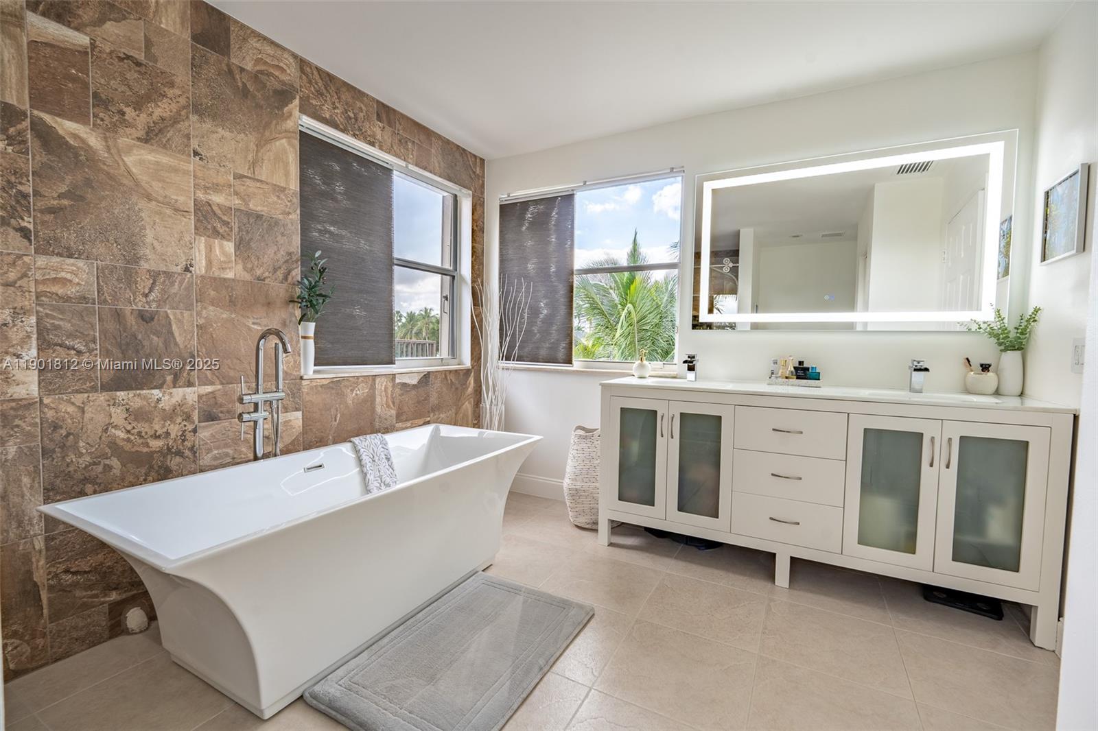 18004 Southwest 20th Street Miramar, FL 33029 - Photo 40 of 49 a bathroom with a tub a sink and a large window