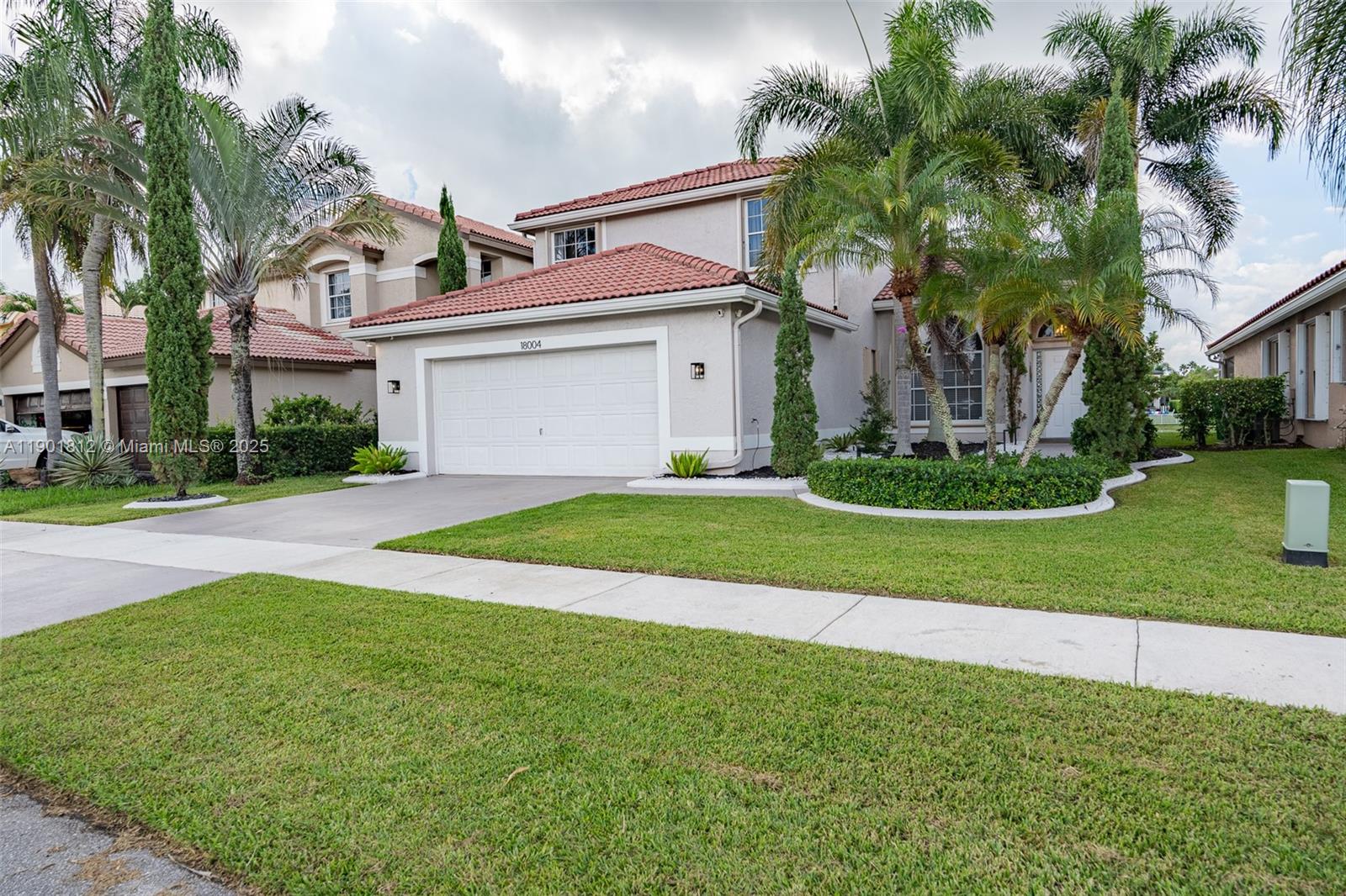18004 Southwest 20th Street Miramar, FL 33029 - Photo 4 of 49 a front view of a house with a yard and garage