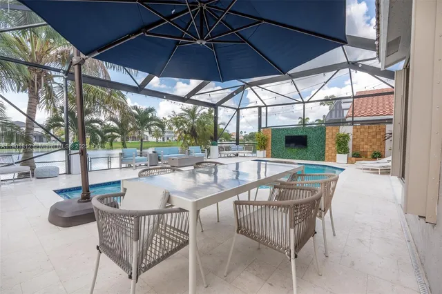 a view of a patio with couches and a fire pit
